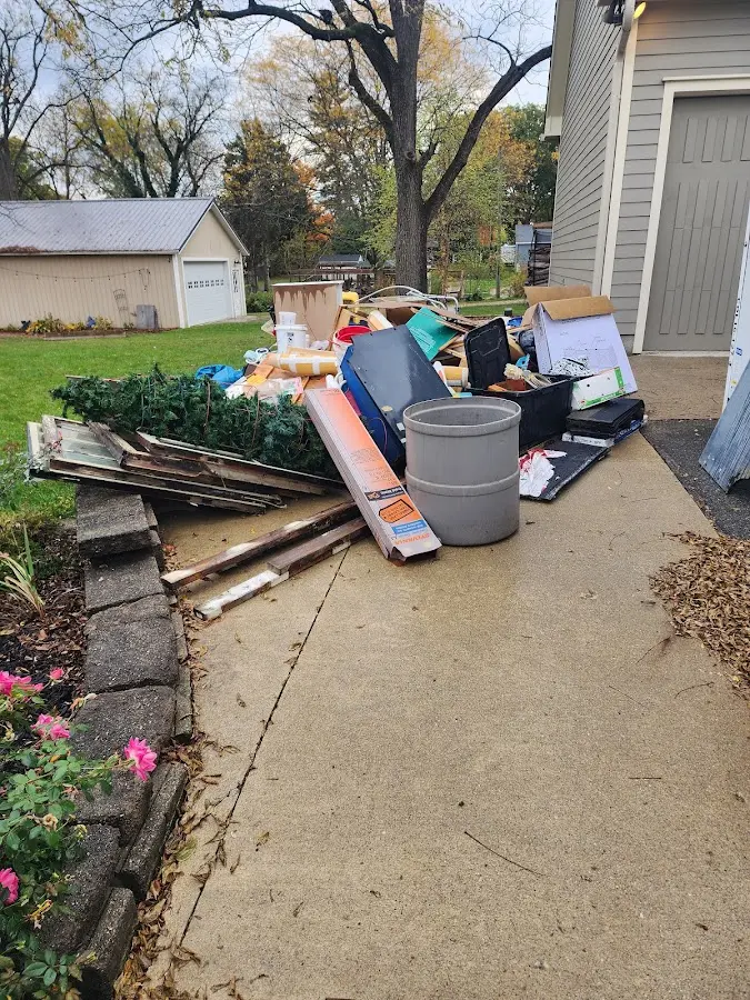 Dumpster being loaded with debris for 12 Yard Dumpster Rental in Ossian